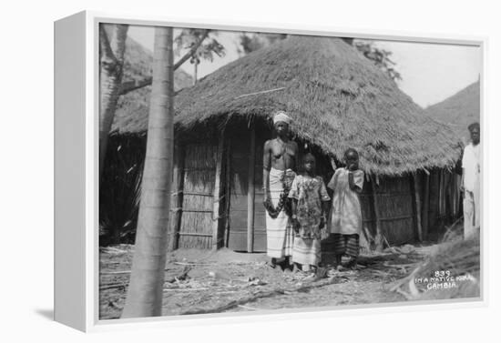 A Family in Front of their Home, Gambia, 20th Century-null-Framed Premier Image Canvas