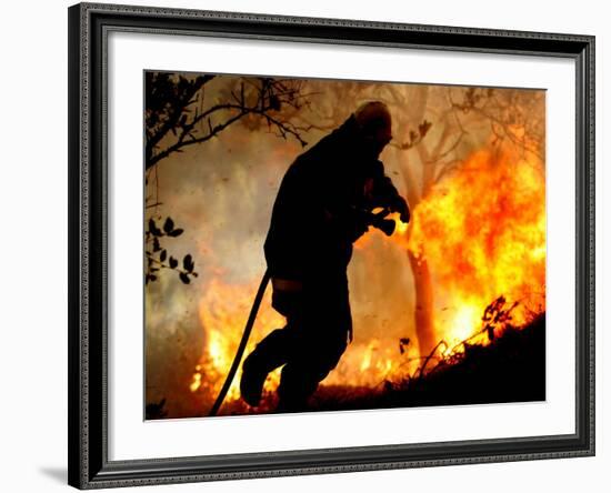 A Fire Fighter Retreats from a Forest Fire Near Fraldeu, Central Portugal-null-Framed Photographic Print