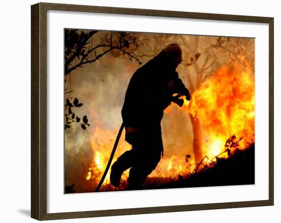 A Fire Fighter Retreats from a Forest Fire Near Fraldeu, Central Portugal-null-Framed Photographic Print