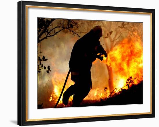 A Fire Fighter Retreats from a Forest Fire Near Fraldeu, Central Portugal-null-Framed Photographic Print