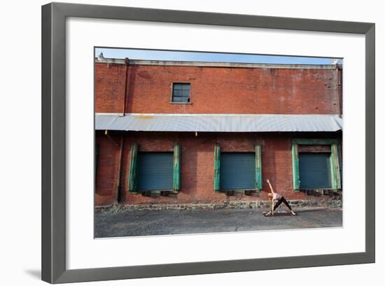 A Fit, Blonde Woman Does Yoga In Front Of An Old Brick Warehouse In Downtown Spokane, Washington-Ben Herndon-Framed Photographic Print
