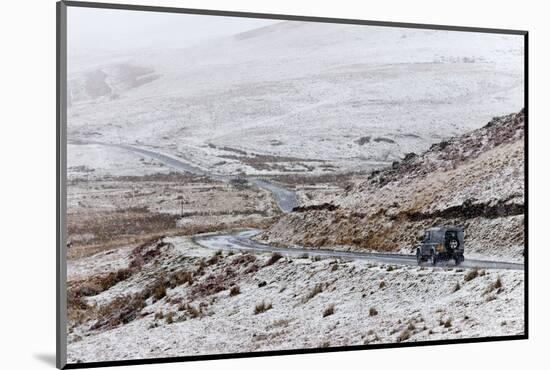 A Four Wheel Drive Vehicle Negotiates a Road Through a Wintry Landscape in Elan Valley Area, Wales-Graham Lawrence-Mounted Photographic Print
