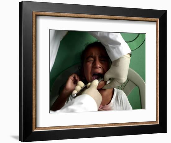 A Girl, 6, Cries as Dentist Allan Castellanos Removes a Molar Toot-null-Framed Photographic Print