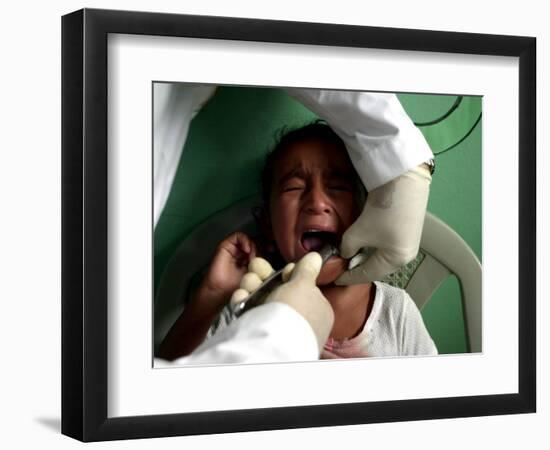 A Girl, 6, Cries as Dentist Allan Castellanos Removes a Molar Toot-null-Framed Photographic Print
