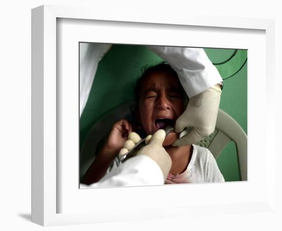 A Girl, 6, Cries as Dentist Allan Castellanos Removes a Molar Toot-null-Framed Photographic Print