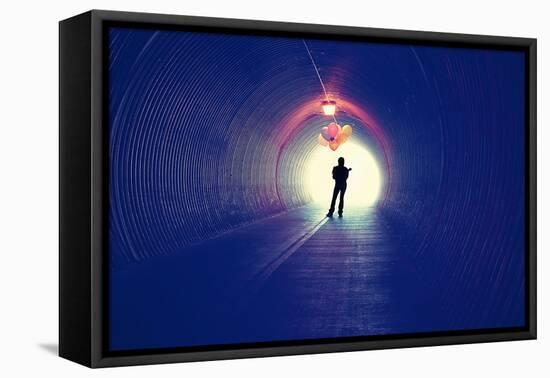A Girl at the End of a Tunnel Holding Balloons-graphicphoto-Framed Premier Image Canvas