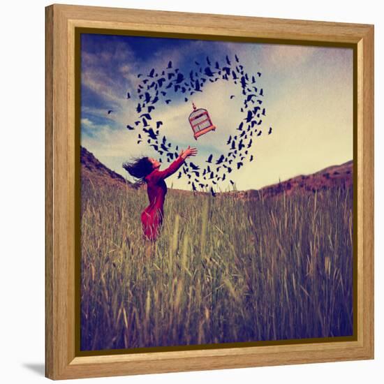 A Girl in a Field Tossing a Birdcage in the Air with Birds Flying in the Shape of a Heart Toned Wit-graphicphoto-Framed Premier Image Canvas