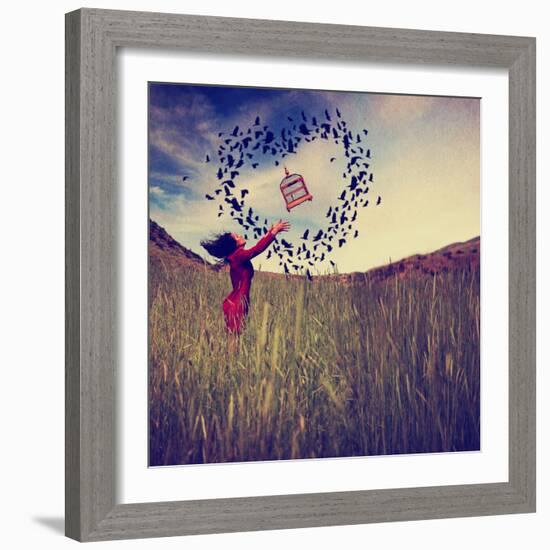 A Girl in a Field Tossing a Birdcage in the Air with Birds Flying in the Shape of a Heart Toned Wit-graphicphoto-Framed Photographic Print