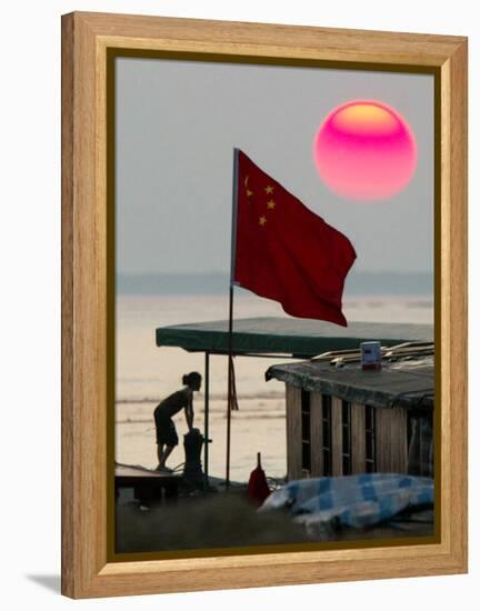 A Girl Rests on a Boat Below the Chinese National Flag-null-Framed Premier Image Canvas