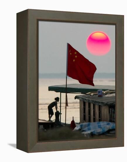 A Girl Rests on a Boat Below the Chinese National Flag-null-Framed Premier Image Canvas