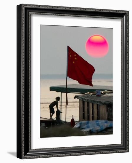 A Girl Rests on a Boat Below the Chinese National Flag-null-Framed Photographic Print