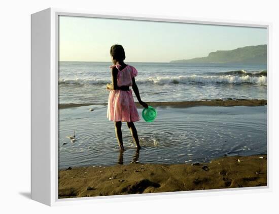 A Girl Walks on the Beach in Jacmel, Haiti, in This February 5, 2001-Lynne Sladky-Framed Premier Image Canvas