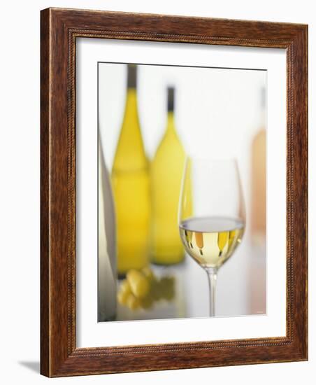 A Glass of White Wine and Wine Bottles in Background-Ulrike Koeb-Framed Photographic Print