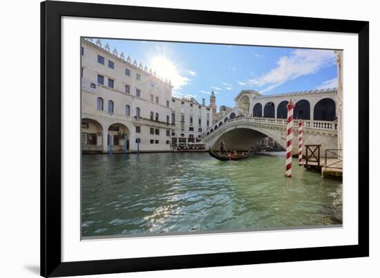 A gondolier rowing under Rialto Bridge in Venice, UNESCO World Heritage Site, Veneto, Italy, Europe-Nando Machado-Framed Photographic Print