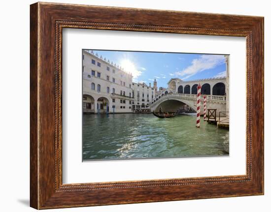 A gondolier rowing under Rialto Bridge in Venice, UNESCO World Heritage Site, Veneto, Italy, Europe-Nando Machado-Framed Photographic Print