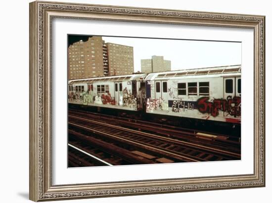 A Graffiti Painted Subway Train with Housing Projects in the Background, May 1973-null-Framed Photo