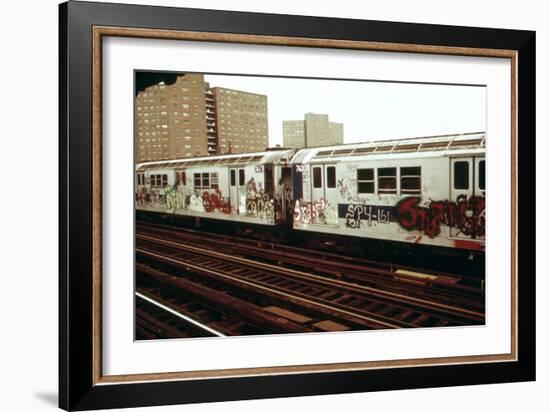 A Graffiti Painted Subway Train with Housing Projects in the Background, May 1973-null-Framed Photo