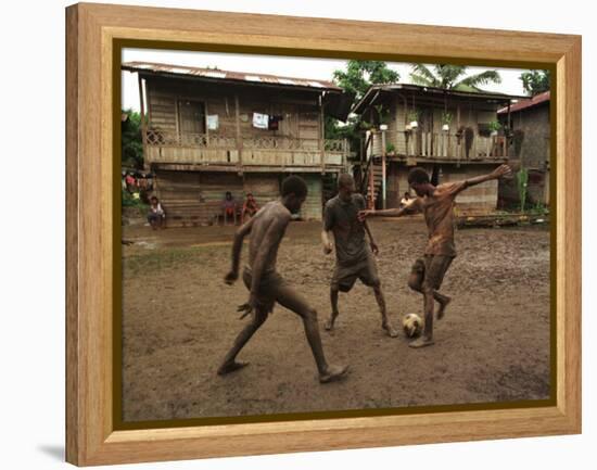 A Group of Panamanian Youths Slide Through the Mud During a Pick-Up Game of Soccer-null-Framed Premier Image Canvas