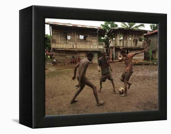 A Group of Panamanian Youths Slide Through the Mud During a Pick-Up Game of Soccer-null-Framed Premier Image Canvas