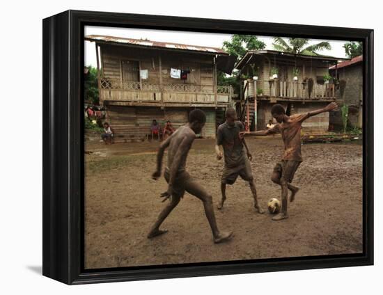 A Group of Panamanian Youths Slide Through the Mud During a Pick-Up Game of Soccer-null-Framed Premier Image Canvas