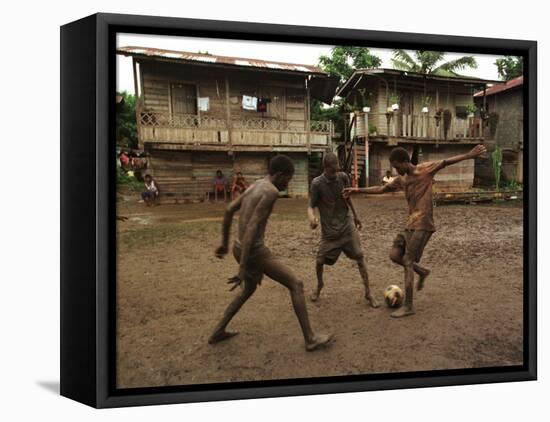 A Group of Panamanian Youths Slide Through the Mud During a Pick-Up Game of Soccer-null-Framed Premier Image Canvas