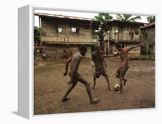 A Group of Panamanian Youths Slide Through the Mud During a Pick-Up Game of Soccer-null-Framed Premier Image Canvas