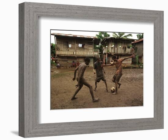 A Group of Panamanian Youths Slide Through the Mud During a Pick-Up Game of Soccer-null-Framed Photographic Print