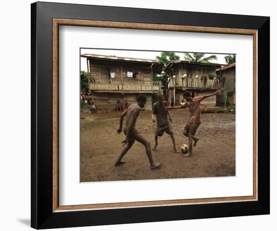 A Group of Panamanian Youths Slide Through the Mud During a Pick-Up Game of Soccer-null-Framed Photographic Print