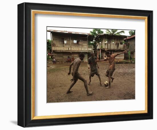 A Group of Panamanian Youths Slide Through the Mud During a Pick-Up Game of Soccer-null-Framed Photographic Print