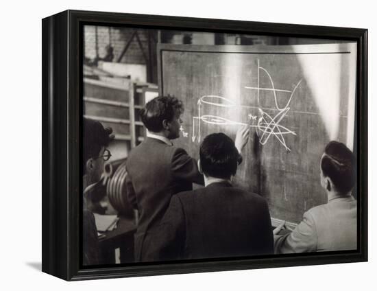 A Group of Scientists Study a Problem by Using Diagrams on a Blackboard-Henry Grant-Framed Premier Image Canvas