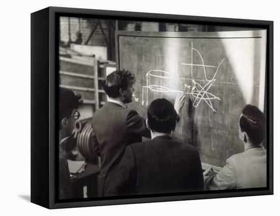 A Group of Scientists Study a Problem by Using Diagrams on a Blackboard-Henry Grant-Framed Premier Image Canvas