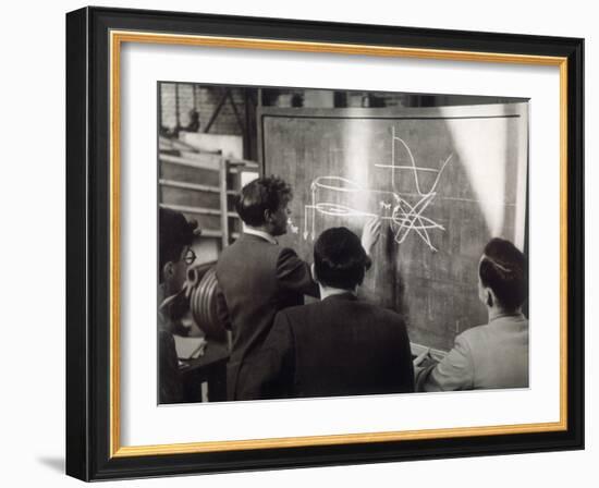 A Group of Scientists Study a Problem by Using Diagrams on a Blackboard-Henry Grant-Framed Premium Photographic Print
