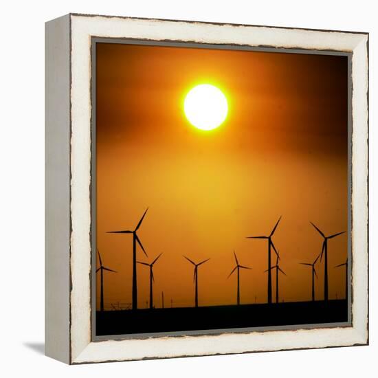A Group of Wind Turbines are Silhouetted by the Setting Sun-Charlie Riedel-Framed Premier Image Canvas