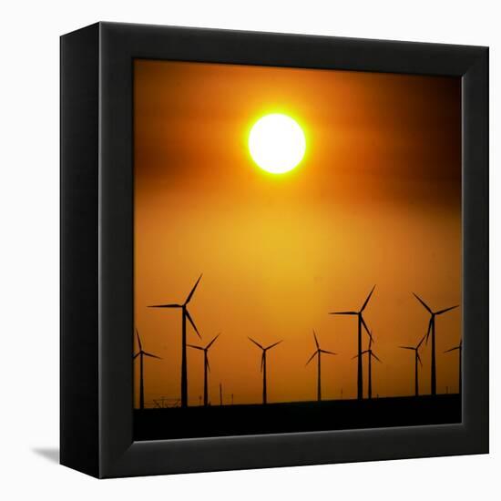 A Group of Wind Turbines are Silhouetted by the Setting Sun-Charlie Riedel-Framed Premier Image Canvas