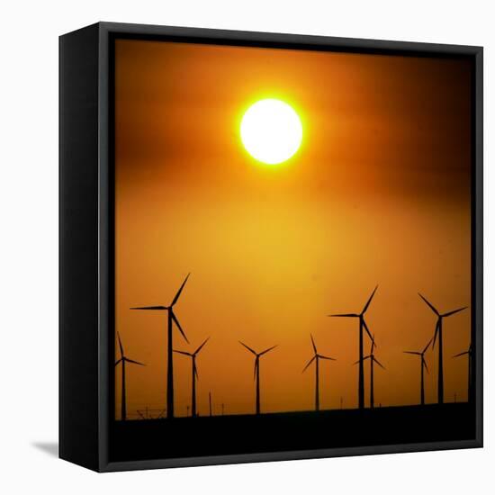 A Group of Wind Turbines are Silhouetted by the Setting Sun-Charlie Riedel-Framed Premier Image Canvas