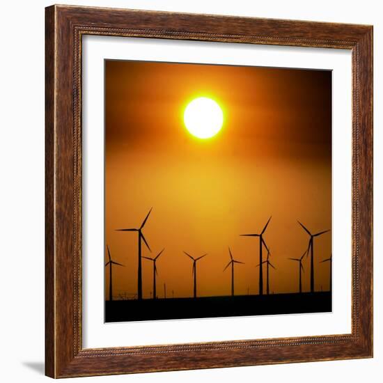 A Group of Wind Turbines are Silhouetted by the Setting Sun-Charlie Riedel-Framed Photographic Print