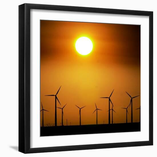 A Group of Wind Turbines are Silhouetted by the Setting Sun-Charlie Riedel-Framed Photographic Print