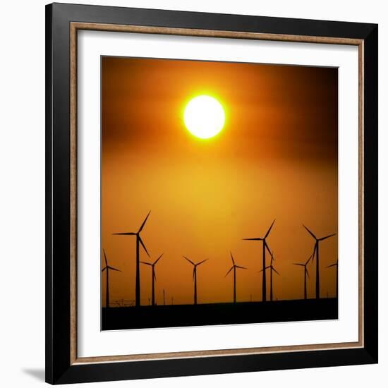 A Group of Wind Turbines are Silhouetted by the Setting Sun-Charlie Riedel-Framed Photographic Print