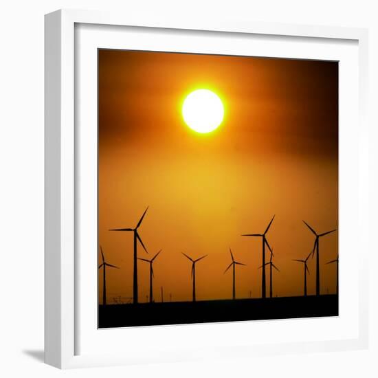 A Group of Wind Turbines are Silhouetted by the Setting Sun-Charlie Riedel-Framed Photographic Print