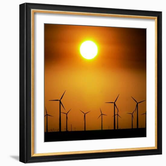 A Group of Wind Turbines are Silhouetted by the Setting Sun-Charlie Riedel-Framed Photographic Print