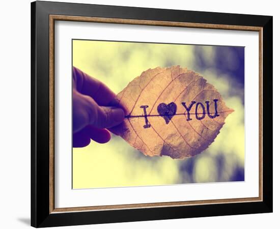 A Hand Holding a Leaf that Reads I Love You in Ink up to the Sky on a Dreary Day (Very Shallow De-graphicphoto-Framed Photographic Print