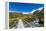 A hiking trail crosses wooden bridge over a creak high up in the mountains, New Zealand-Logan Brown-Framed Premier Image Canvas