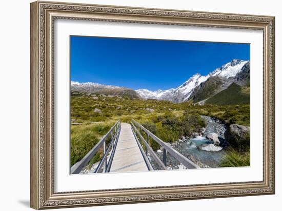 A hiking trail crosses wooden bridge over a creak high up in the mountains, New Zealand-Logan Brown-Framed Photographic Print