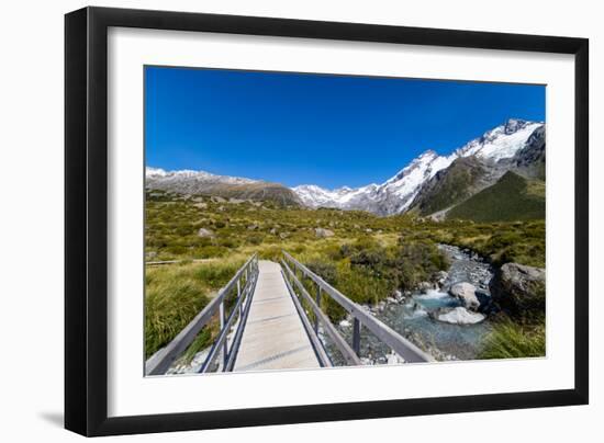 A hiking trail crosses wooden bridge over a creak high up in the mountains, New Zealand-Logan Brown-Framed Photographic Print