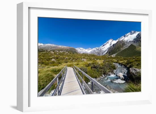 A hiking trail crosses wooden bridge over a creak high up in the mountains, New Zealand-Logan Brown-Framed Photographic Print