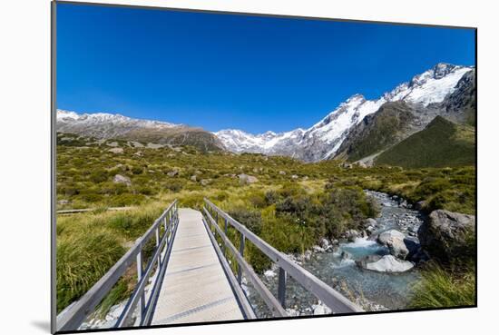 A hiking trail crosses wooden bridge over a creak high up in the mountains, New Zealand-Logan Brown-Mounted Photographic Print