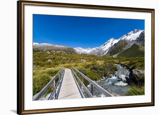 A hiking trail crosses wooden bridge over a creak high up in the mountains, New Zealand-Logan Brown-Framed Photographic Print