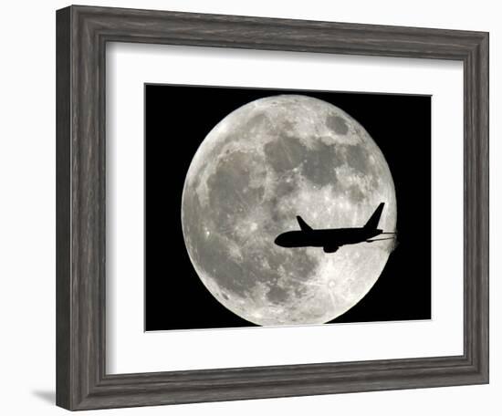 A Jet Plane Passes in Front of the Full Moon Above Surfside, Fla.-null-Framed Photographic Print