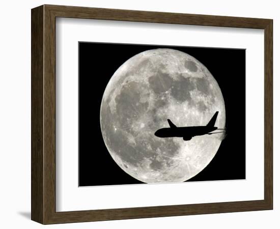 A Jet Plane Passes in Front of the Full Moon Above Surfside, Fla.-null-Framed Photographic Print