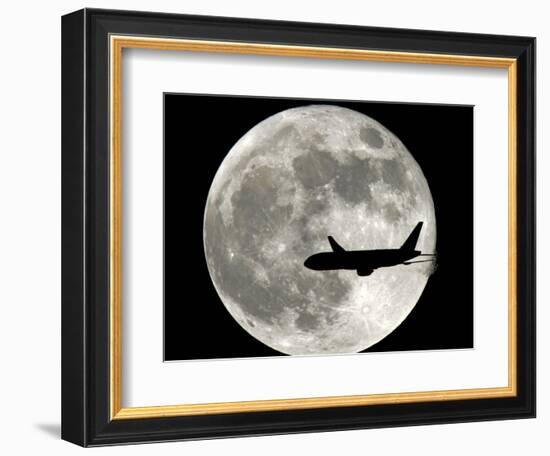 A Jet Plane Passes in Front of the Full Moon Above Surfside, Fla.-null-Framed Photographic Print